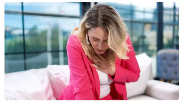 Man experiencing chest pain, a potential heart attack symptom.
