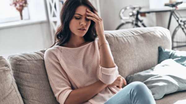Woman experiencing fatigue, an early warning sign of heart attack.