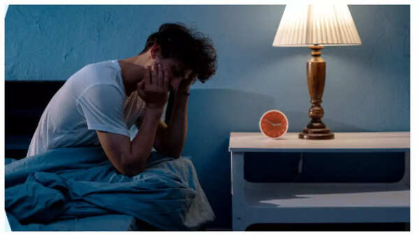 Sleepless woman, highlighting sleep disturbances as a warning sign.