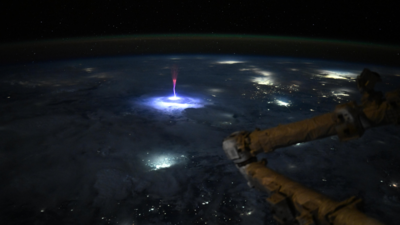 Astronaut captures a rare red sprite above thunderstorms.
