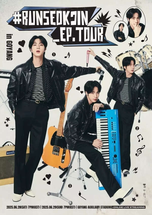 Jin waving to the crowd during his solo concert