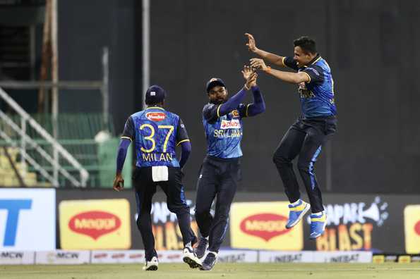 Sri Lankan fielders celebrate a crucial dismissal.